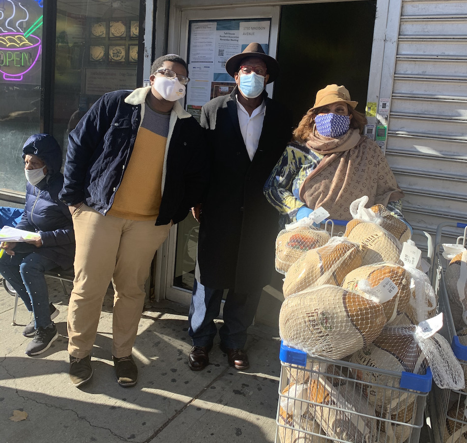 Repair the World staff and volunteers hand out donated turkeys at Taft Houses