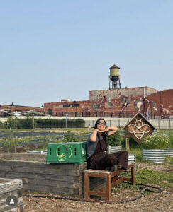 Emily Levine sits in an urban garden in Detroit.