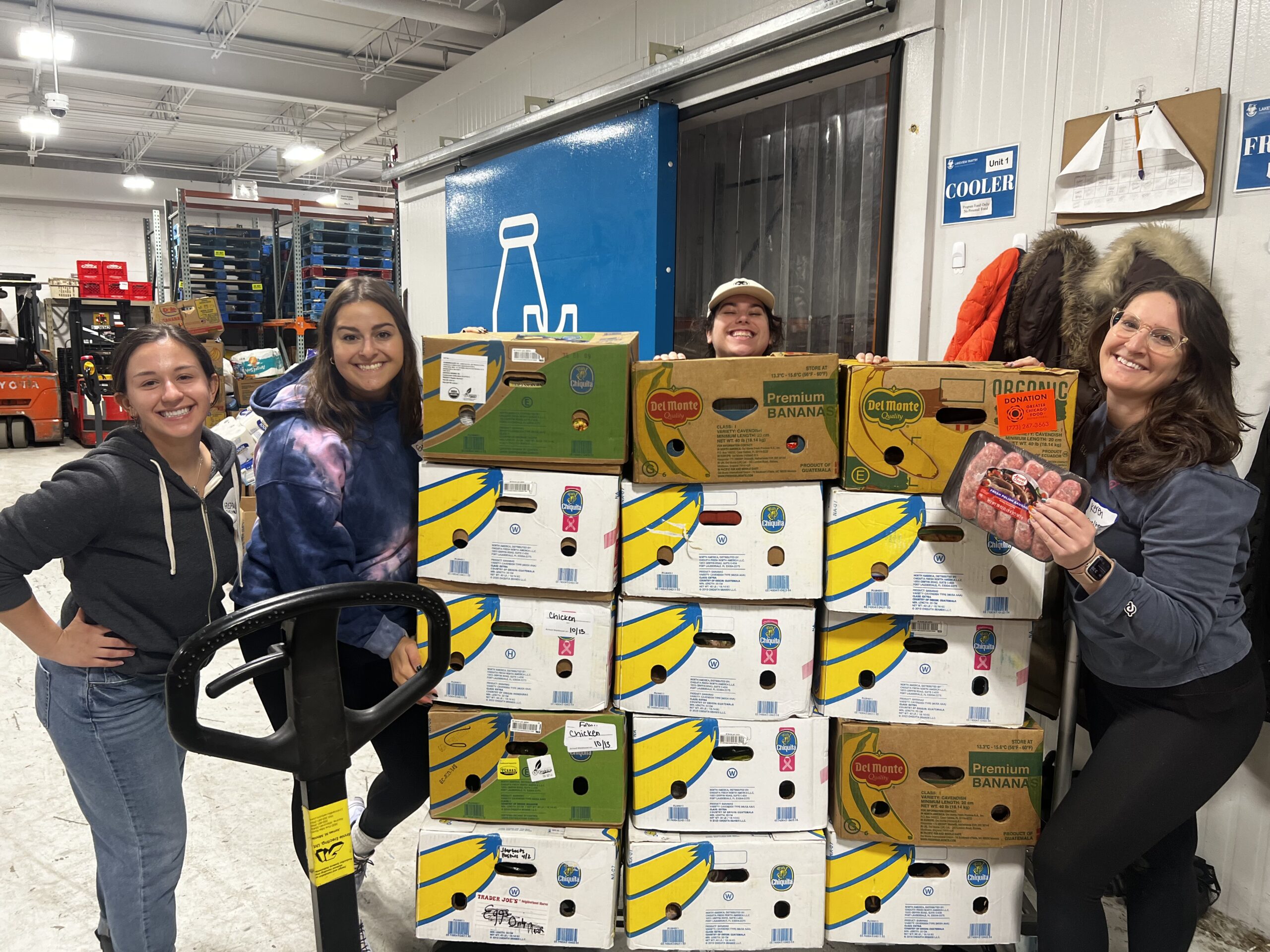 Repair the World Chicago volunteers sorting food donations for families facing food insecurity.