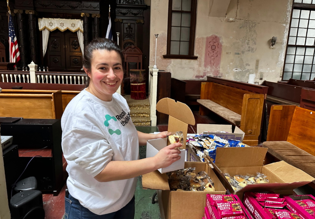 Volunteer organizing and packing meal kits